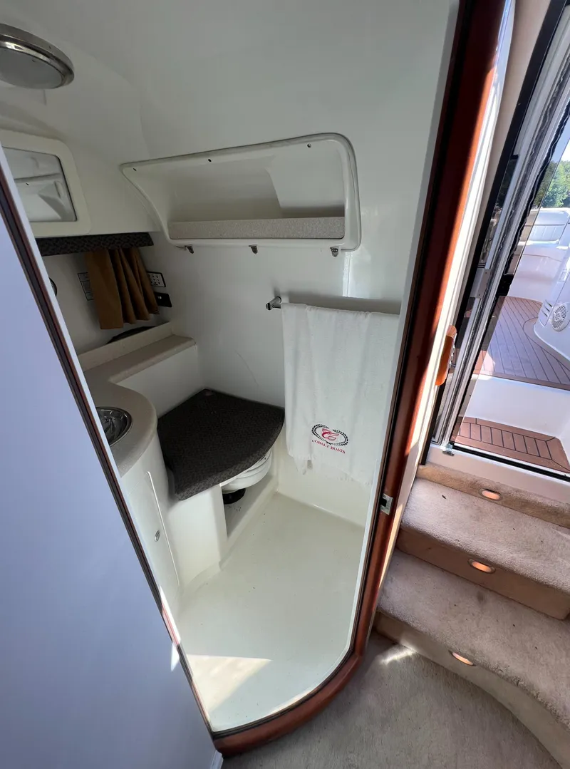 Slide: The Image of Compact bathroom in a 2003 Cobalt 360 boat with sink, toilet, and towel rack. - 38