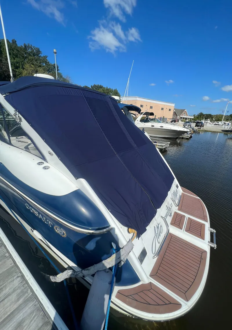 Slide: The Image of 2003 Cobalt 360 boat docked at a marina under a clear blue sky. - 4
