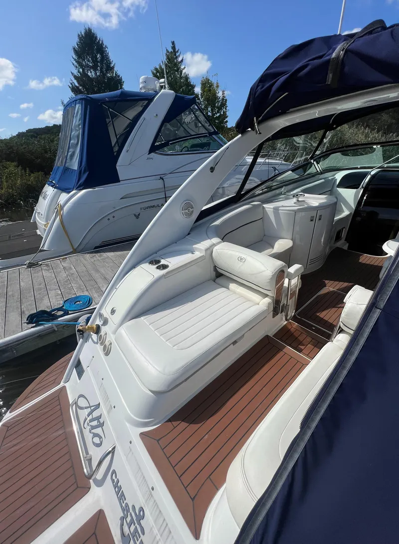 Slide: The Image of 2003 Cobalt 360 boat docked, featuring spacious seating and sleek design. - 7