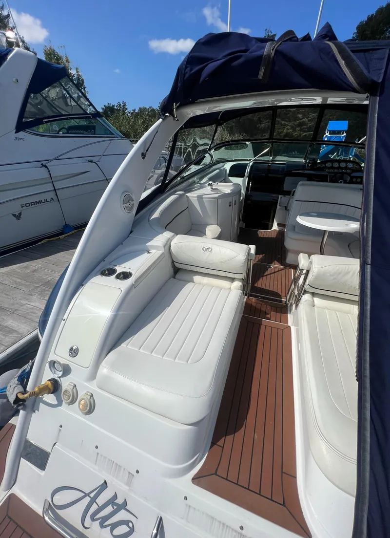 Slide: The Image of 2003 Cobalt 360 boat with white leather seating and wooden deck. - 8