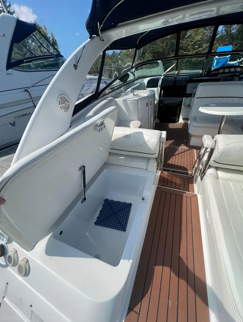 Slide: The Image of 2003 Cobalt 360 boat interior with seating and storage compartments. - 9