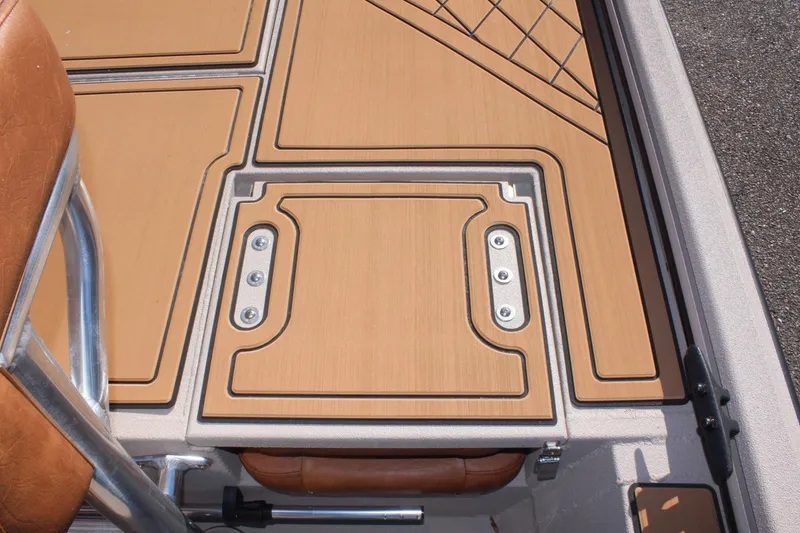 Slide: The Image of 2024 Avid ROGUE boat deck with tan non-slip flooring and storage hatch. - 12