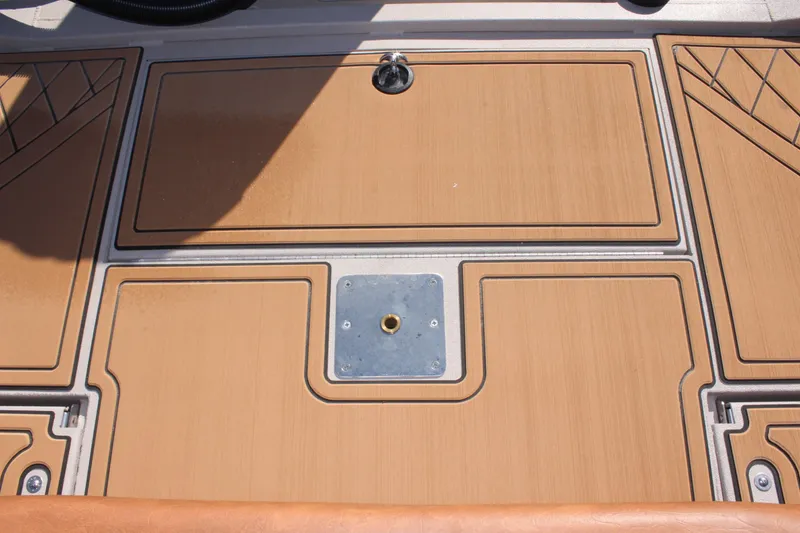 Slide: The Image of 2024 Avid ROGUE boat deck with storage compartments and mounting plate. - 15