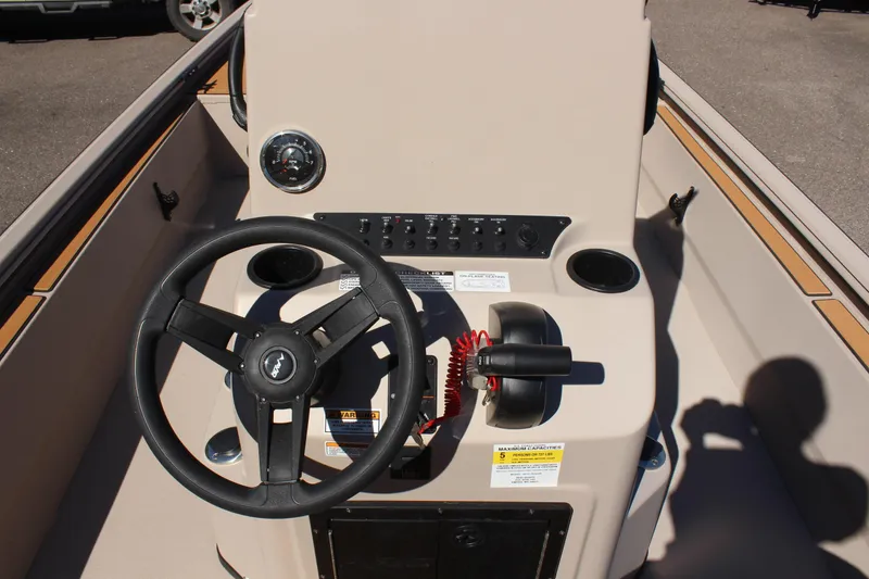 Slide: The Image of 2024 Avid ROGUE boat steering console with control panel and steering wheel. - 16