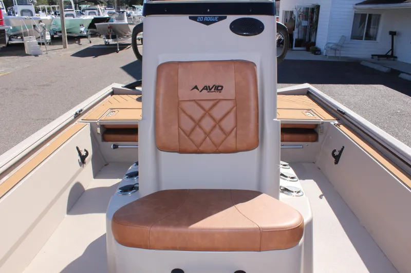 Slide: The Image of Avid ROGUE 2024 boat interior with tan leather seating and storage compartments. - 18