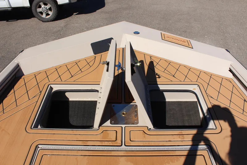 Slide: The Image of 2024 Avid ROGUE boat with open storage compartments on deck. - 22