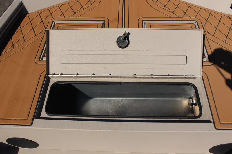 Slide: The Image of 2024 Avid ROGUE boat storage compartment with open lid. - 23