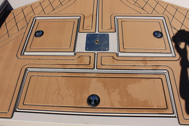 Slide: The Image of 2024 Avid ROGUE boat deck with storage compartments and non-slip surface. - 24