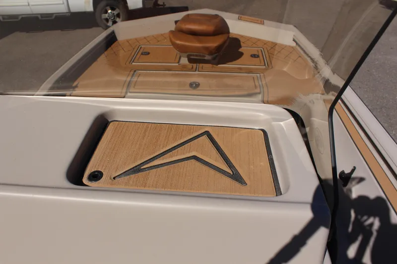Slide: The Image of 2024 Avid ROGUE boat dashboard with wood accents and steering wheel. - 26