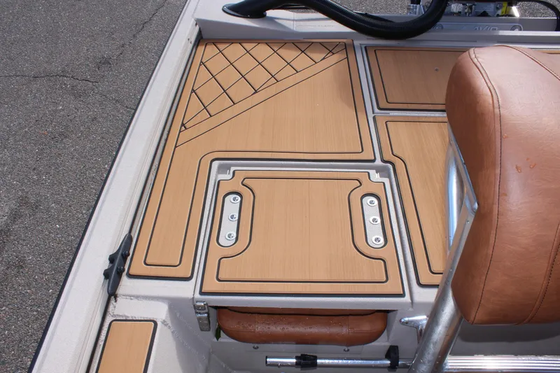 Slide: The Image of 2024 Avid ROGUE boat interior with tan cushioned seat and deck. - 10