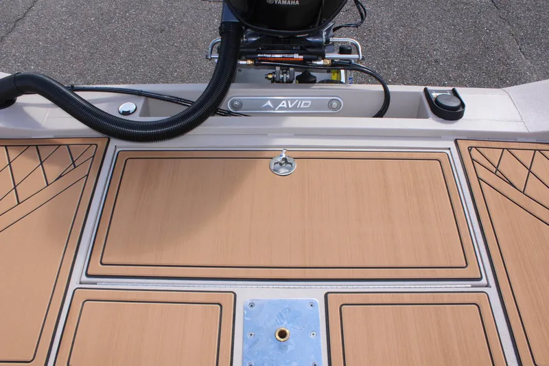 Slide: The Image of 2024 Avid ROGUE boat deck with Yamaha motor and storage compartments. - 12