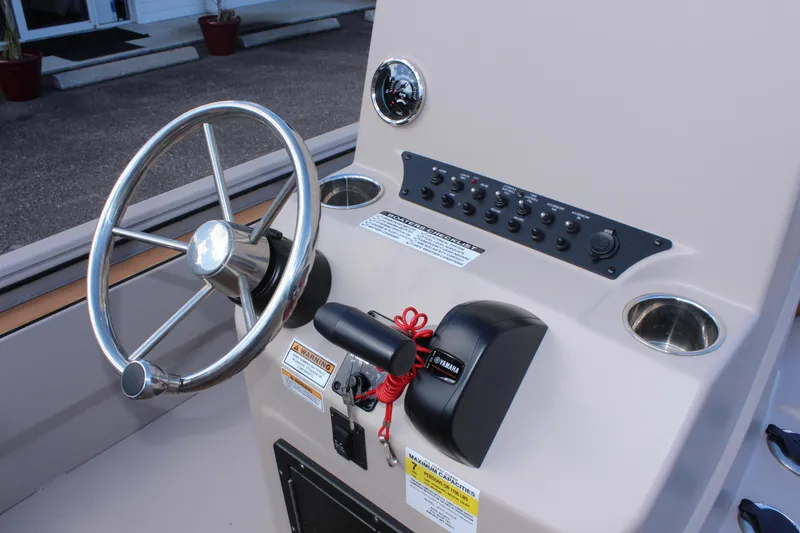 Slide: The Image of 2024 Avid ROGUE boat console with steering wheel and control panel. - 16