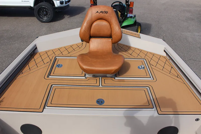 Slide: The Image of 2024 Avid ROGUE boat with tan leather seat and storage compartments. - 19