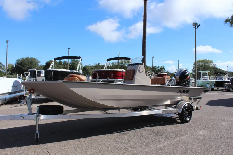 Slide: The Image of 2024 Avid ROGUE boat on a trailer in a marina. - 2