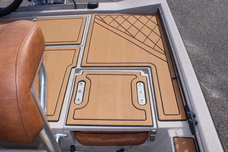 Slide: The Image of 2024 Avid ROGUE boat deck with tan leather seat and wood-patterned flooring. - 8