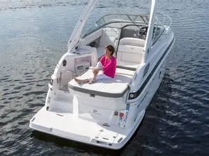 Slide: The Image of 2024 Regal 28 Express boat on water with person relaxing on deck. - 17