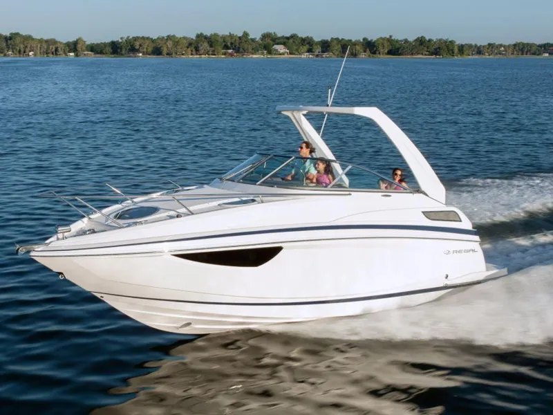 Slide: The Image of 2024 Regal 28 Express boat cruising on a lake. - 2