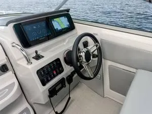 Slide: The Image of 2024 Regal 28 Express boat cockpit with steering wheel and navigation screens. - 21