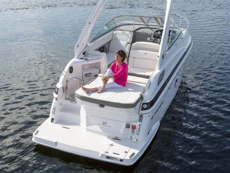 Slide: The Image of 2024 Regal 28 Express boat on water with person relaxing on deck. - 3