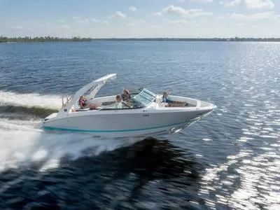 Slide: The Image of 2024 Regal 28 Express boat cruising on a sunny day. - 30