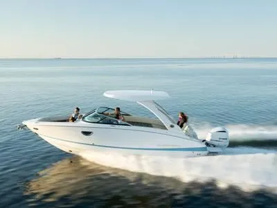 Slide: The Image of 2024 Regal 28 Express boat cruising on open water. - 32