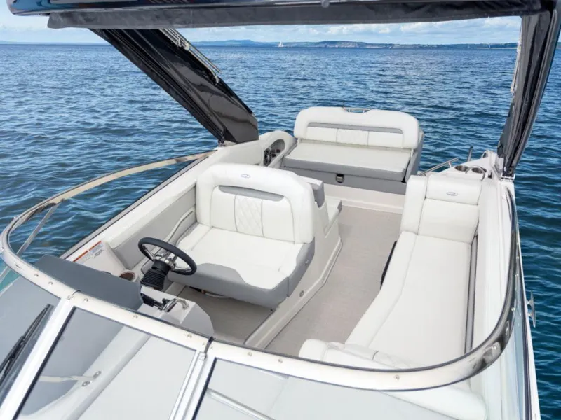 Slide: The Image of 2024 Regal 28 Express boat interior with white seating on open water. - 6
