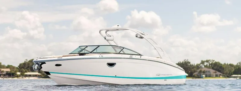 The Image of 2024 Regal LS6 boat on water under a cloudy sky. - 0