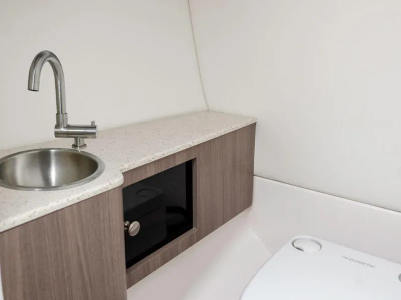 Slide: The Image of 2024 Regal LS6 boat interior bathroom with sink and storage cabinet. - 10