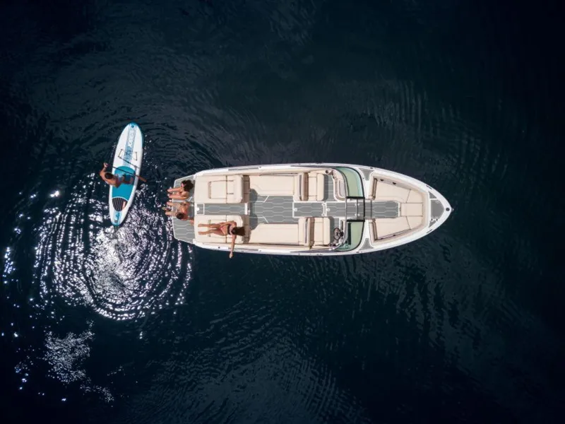 Slide: The Image of Aerial view of 2024 Regal LS6 boat with paddleboarders on calm water. - 4