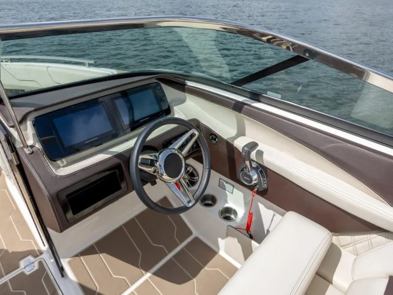 Slide: The Image of 2024 Regal LS6 boat cockpit with modern steering wheel and dual touchscreen displays. - 7
