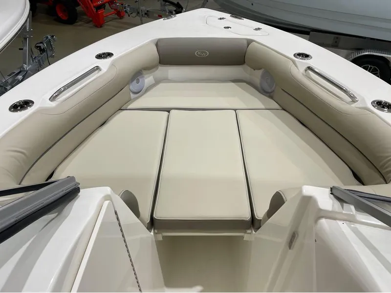 Slide: The Image of 2024 Key West 239 DFS boat interior with cushioned seating and cup holders. - 11