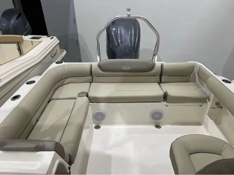 Slide: The Image of 2024 Key West 239 DFS boat interior with cushioned seating and cup holders. - 12