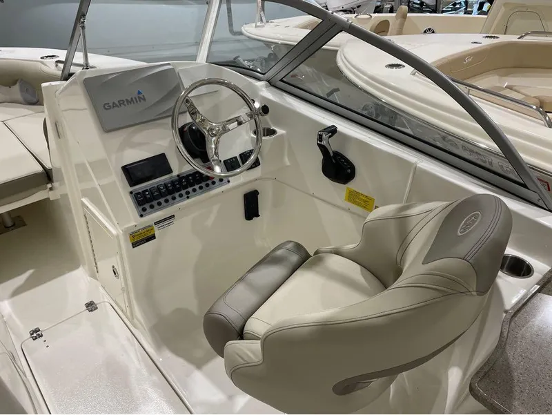 Slide: The Image of 2024 Key West 239 DFS boat cockpit with Garmin navigation system and captain's chair. - 14