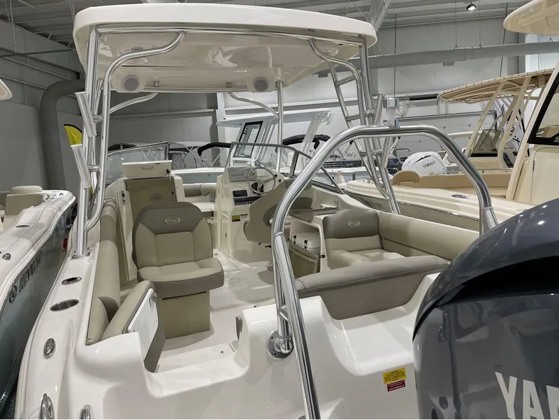 Slide: The Image of 2024 Key West 239 DFS boat interior with seating and steering console in showroom. - 22