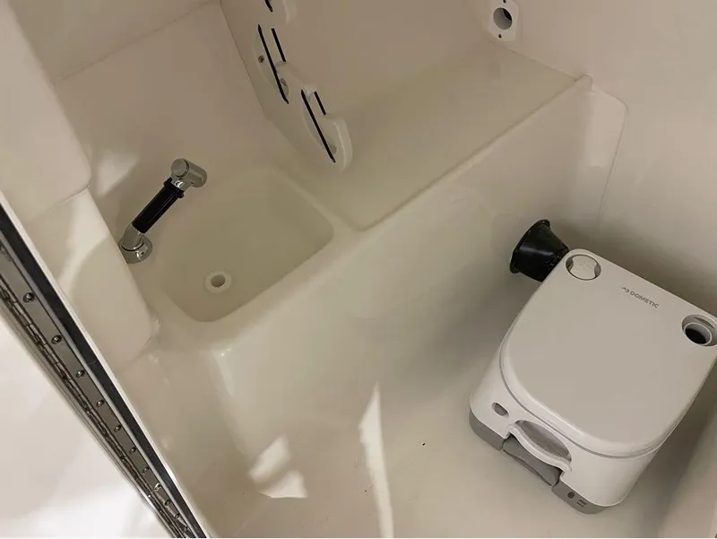 Slide: The Image of 2024 Key West 239 DFS boat interior with sink and portable toilet. - 25