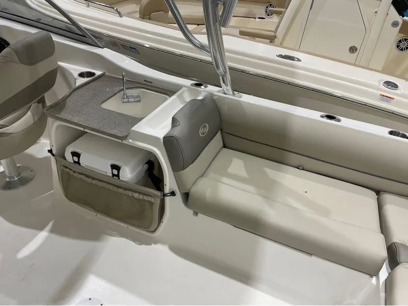 Slide: The Image of 2024 Key West 239 DFS boat interior with seating, sink, and storage. - 9