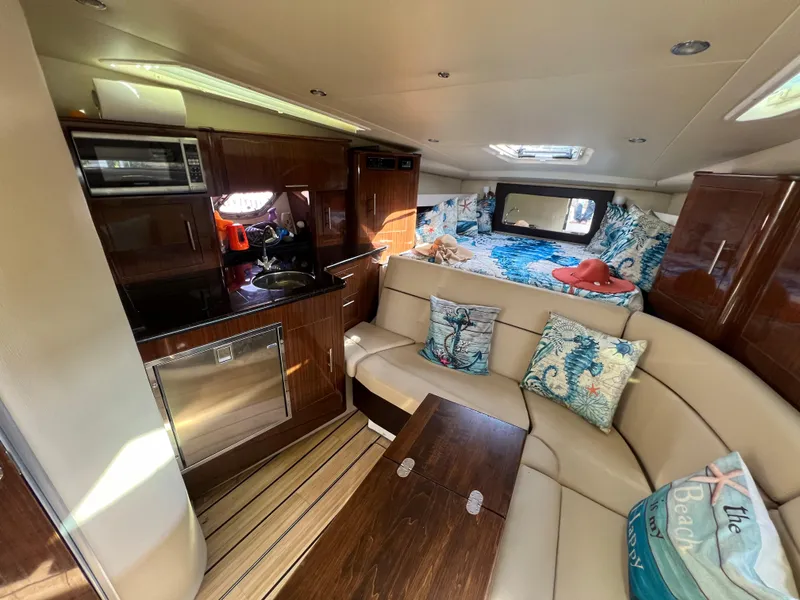 Slide: The Image of Interior of 2014 Regal 35 Sport Coupe with kitchen, seating, and sleeping area. - 11