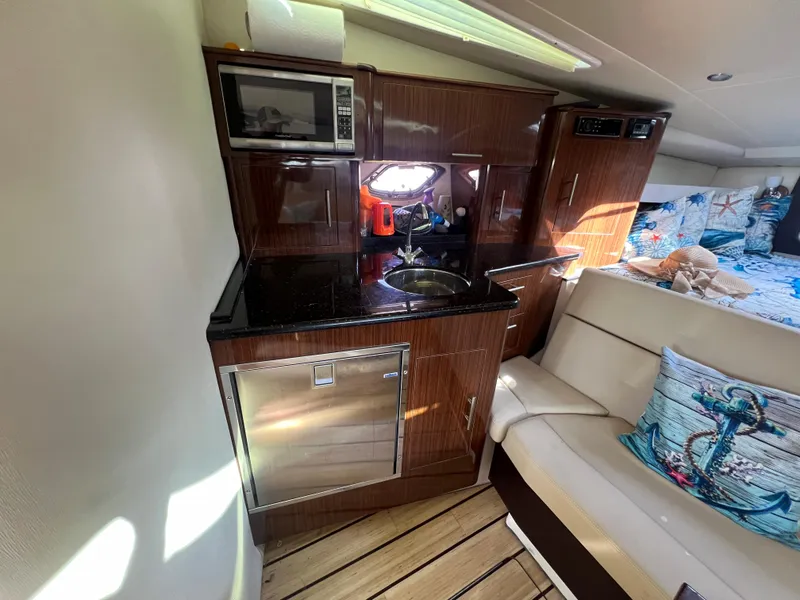 Slide: The Image of 2014 Regal 35 Sport Coupe interior with kitchenette and seating area. - 12