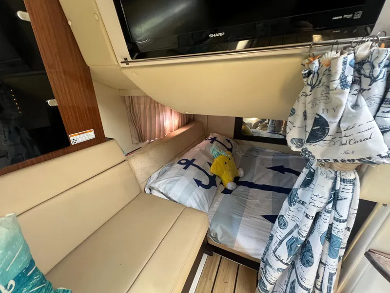 Slide: The Image of Interior cabin of a 2014 Regal 35 Sport Coupe with bed and seating area. - 14