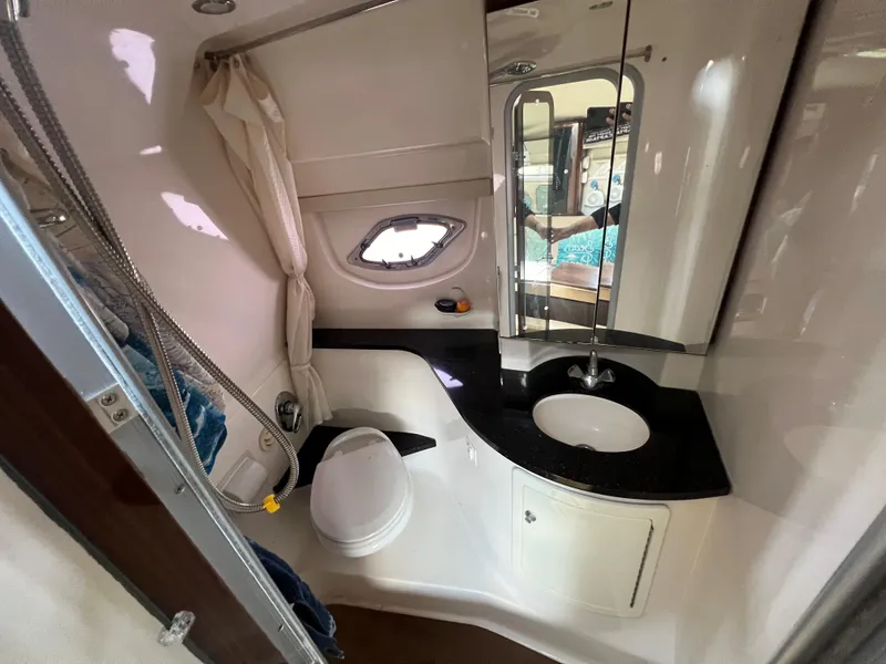 Slide: The Image of 2014 Regal 35 Sport Coupe bathroom with modern fixtures and porthole window. - 15