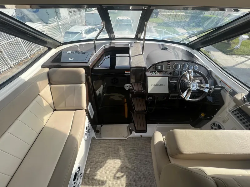 Slide: The Image of Interior cockpit of a 2014 Regal 35 Sport Coupe with beige seating and modern controls. - 16
