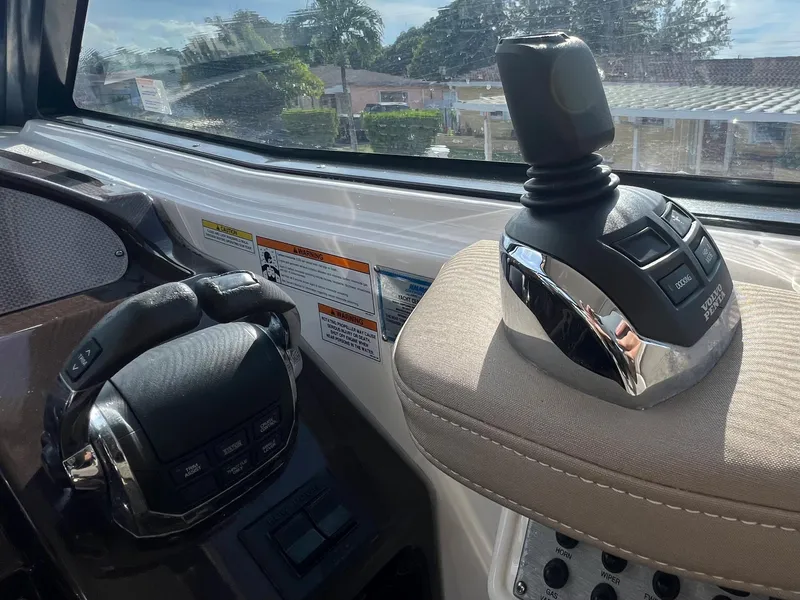 Slide: The Image of Control panel of a 2014 Regal 35 Sport Coupe boat with joystick and steering wheel. - 23