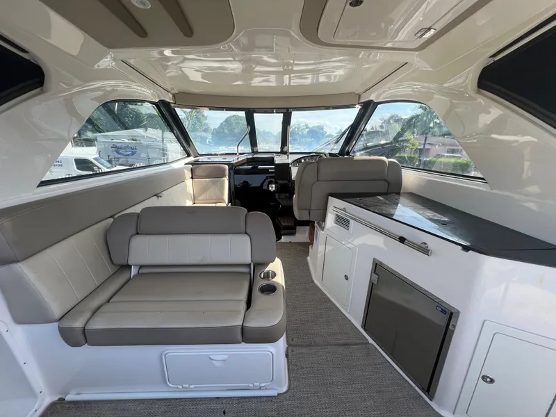 Slide: The Image of Interior of a 2014 Regal 35 Sport Coupe with seating and kitchenette. - 25