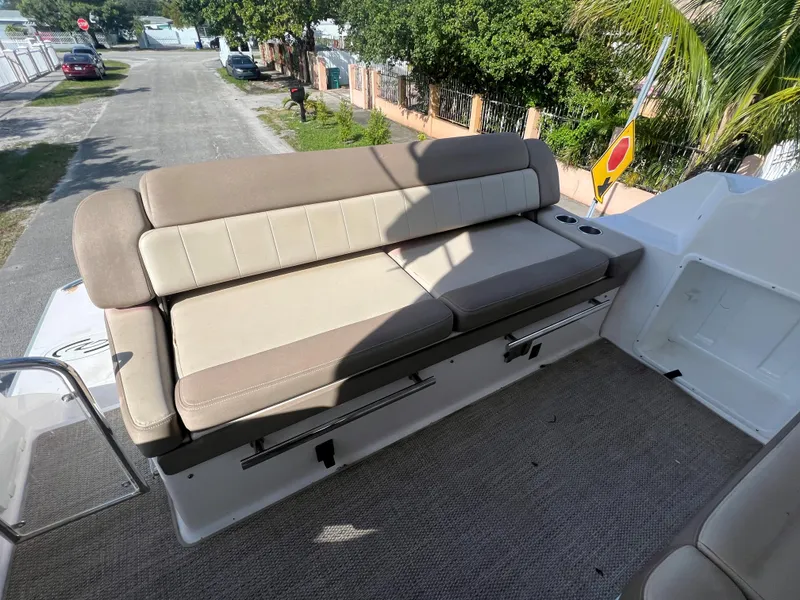 Slide: The Image of 2014 Regal 35 Sport Coupe boat with beige cushioned seating. - 28