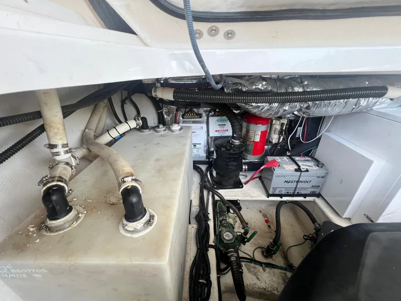 Slide: The Image of Engine compartment of a 2014 Regal 35 Sport Coupe boat showing batteries and wiring. - 33