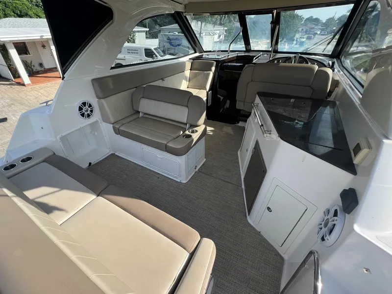 Slide: The Image of 2014 Regal 35 Sport Coupe interior with beige seating and modern amenities. - 36