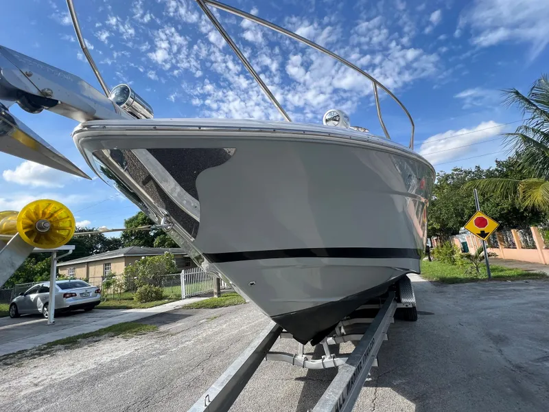 Slide: The Image of 2014 Regal 35 Sport Coupe boat on trailer, clear sky background. - 7