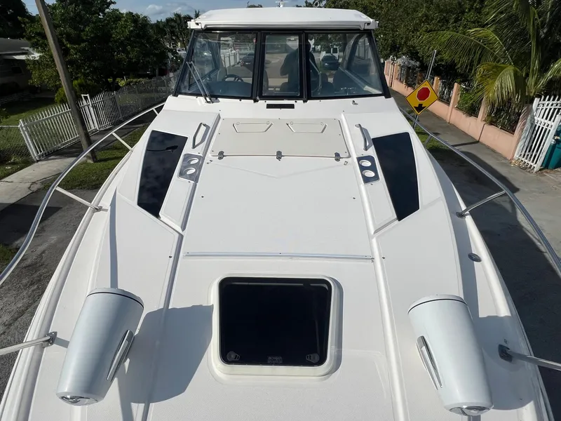 Slide: The Image of 2014 Regal 35 Sport Coupe boat deck with hatch and railing. - 8