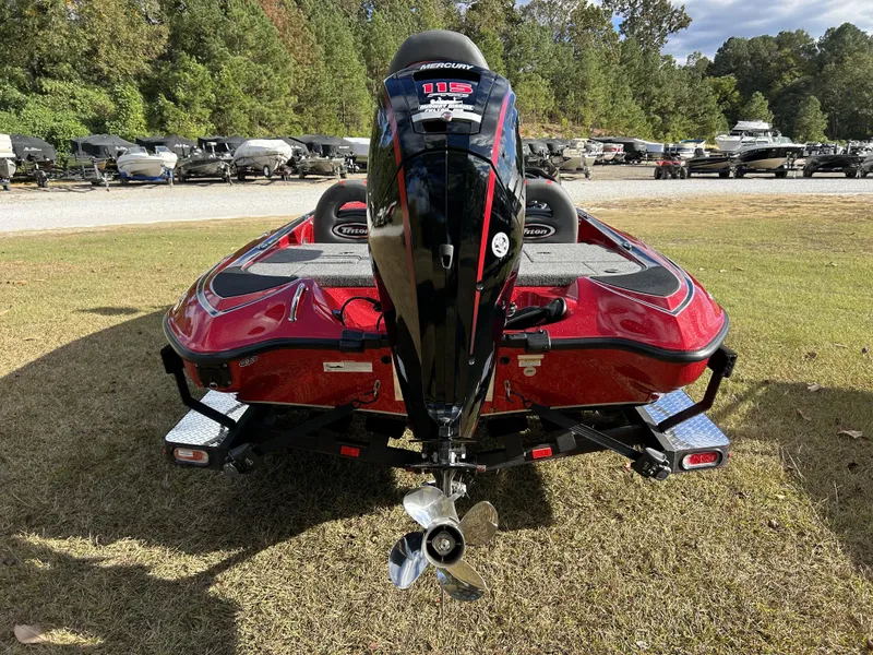 Slide: The Image of 2024 Triton 179 TrX bass boat with Mercury outboard motor, rear view. - 10