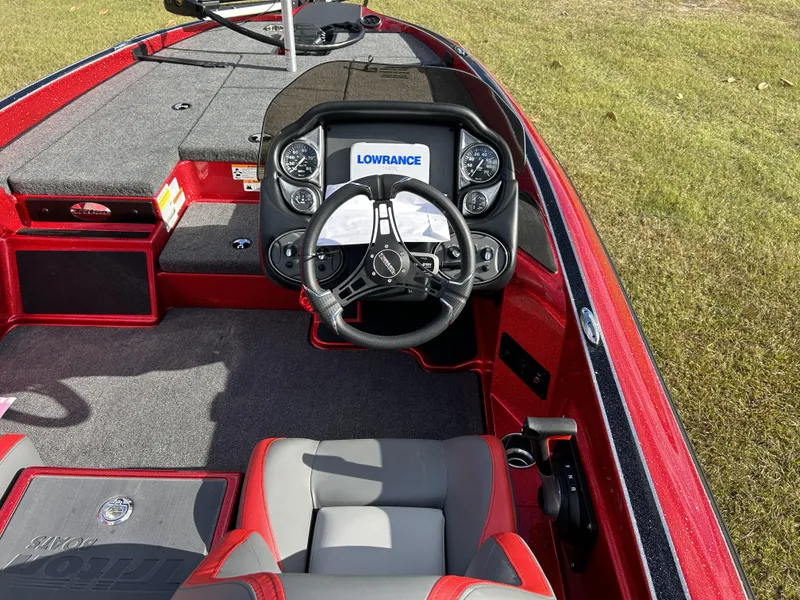 Slide: The Image of 2024 Triton 179 TrX boat interior with steering wheel and Lowrance electronics. - 11